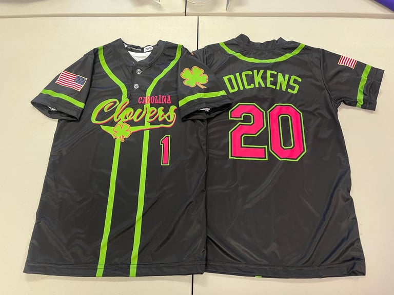 Two black baseball jerseys displayed side-by-side showing Carolina Cherokees number 1 and Dickens number 20 with neon green trim